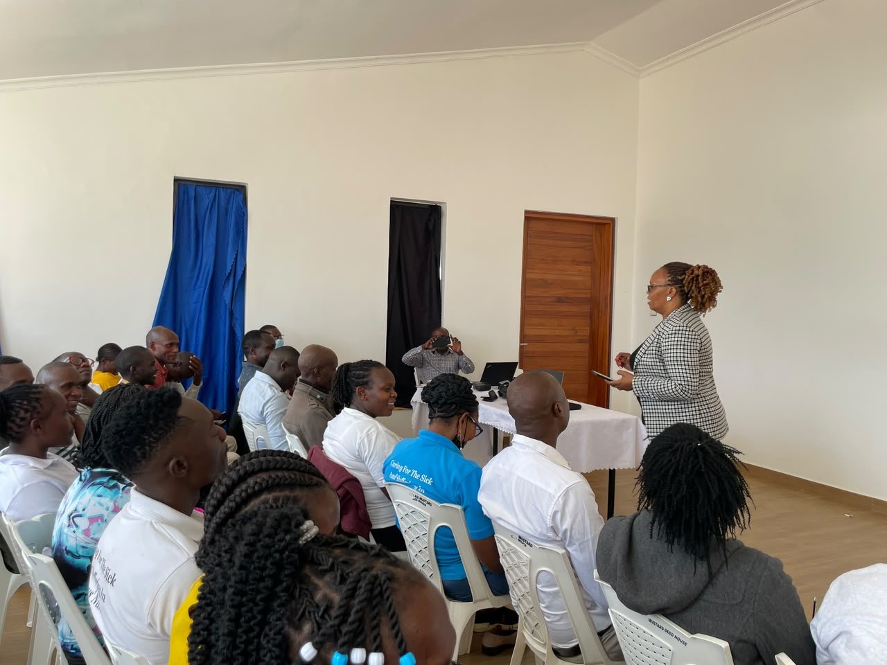 A Wisdom Bridge facilitator addressing Faith Aid staff during a psychological debriefing session